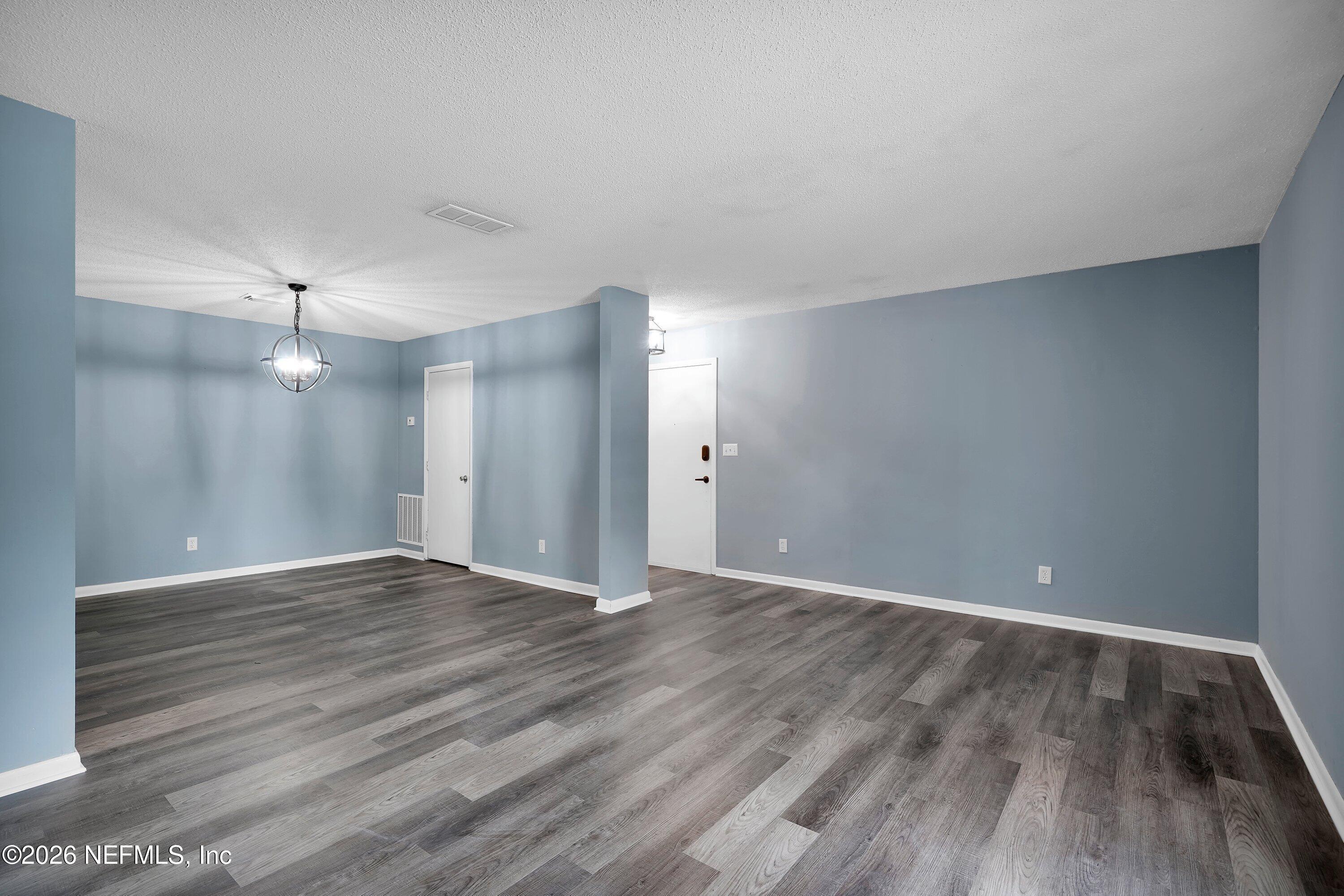 3765 Crown Point Road, Unit 13 Jacksonville, FL 32257 - Photo 11 of 37 a view of an empty room with wooden floor