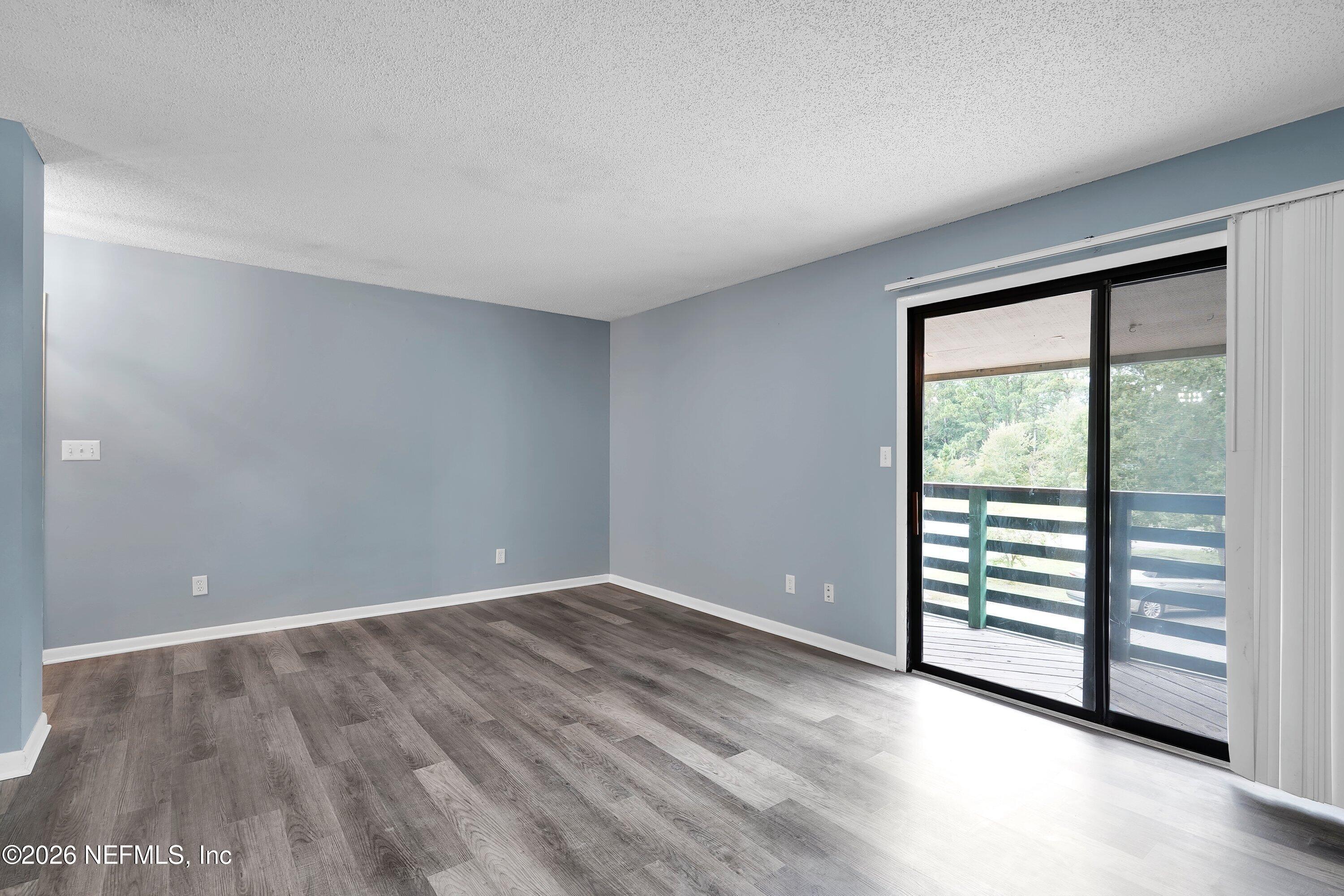 3765 Crown Point Road, Unit 13 Jacksonville, FL 32257 - Photo 12 of 37 wooden floor in an empty room with a window