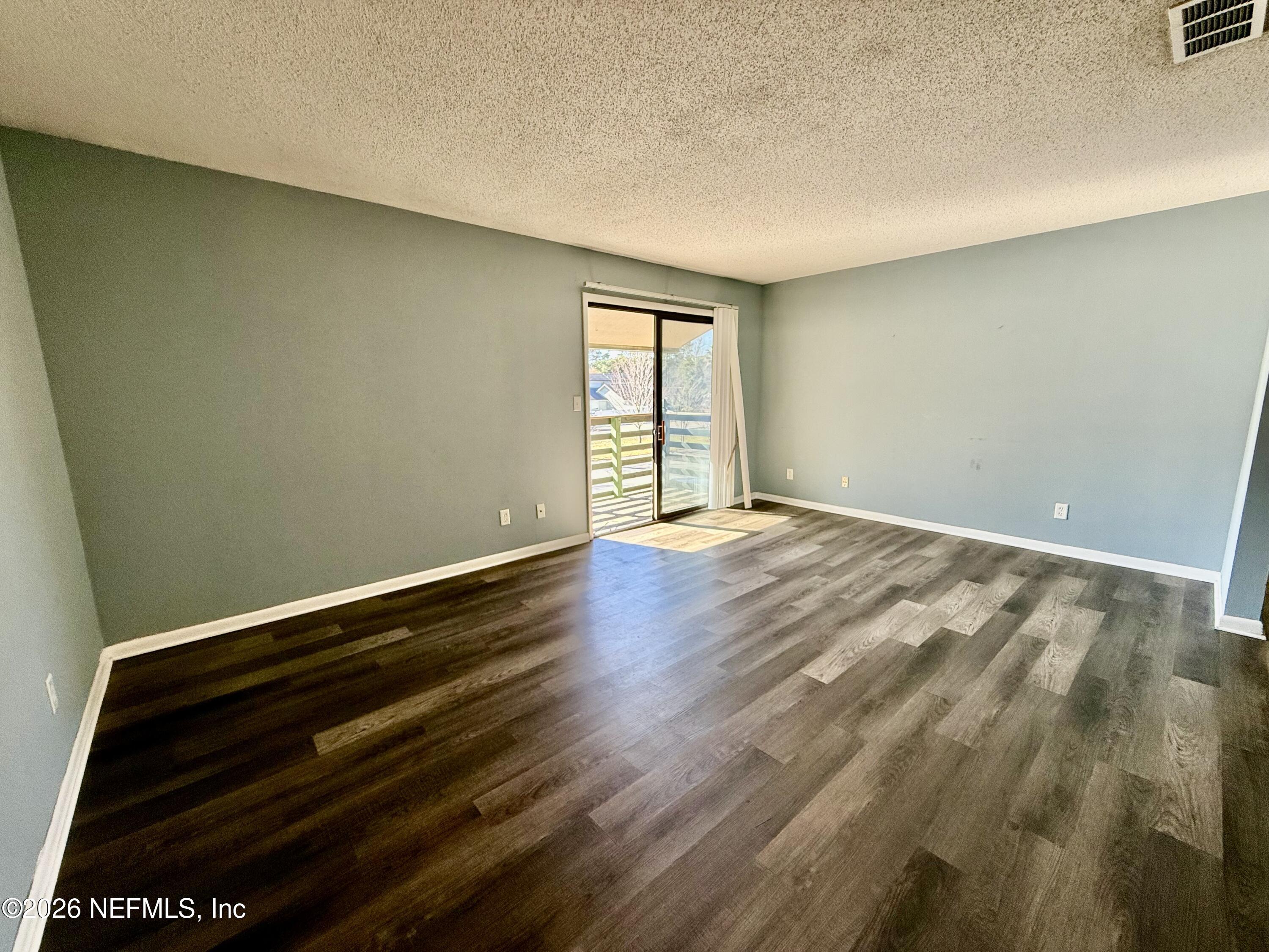 3765 Crown Point Road, Unit 13 Jacksonville, FL 32257 - Photo 20 of 37 a view of room with wooden floor and fan