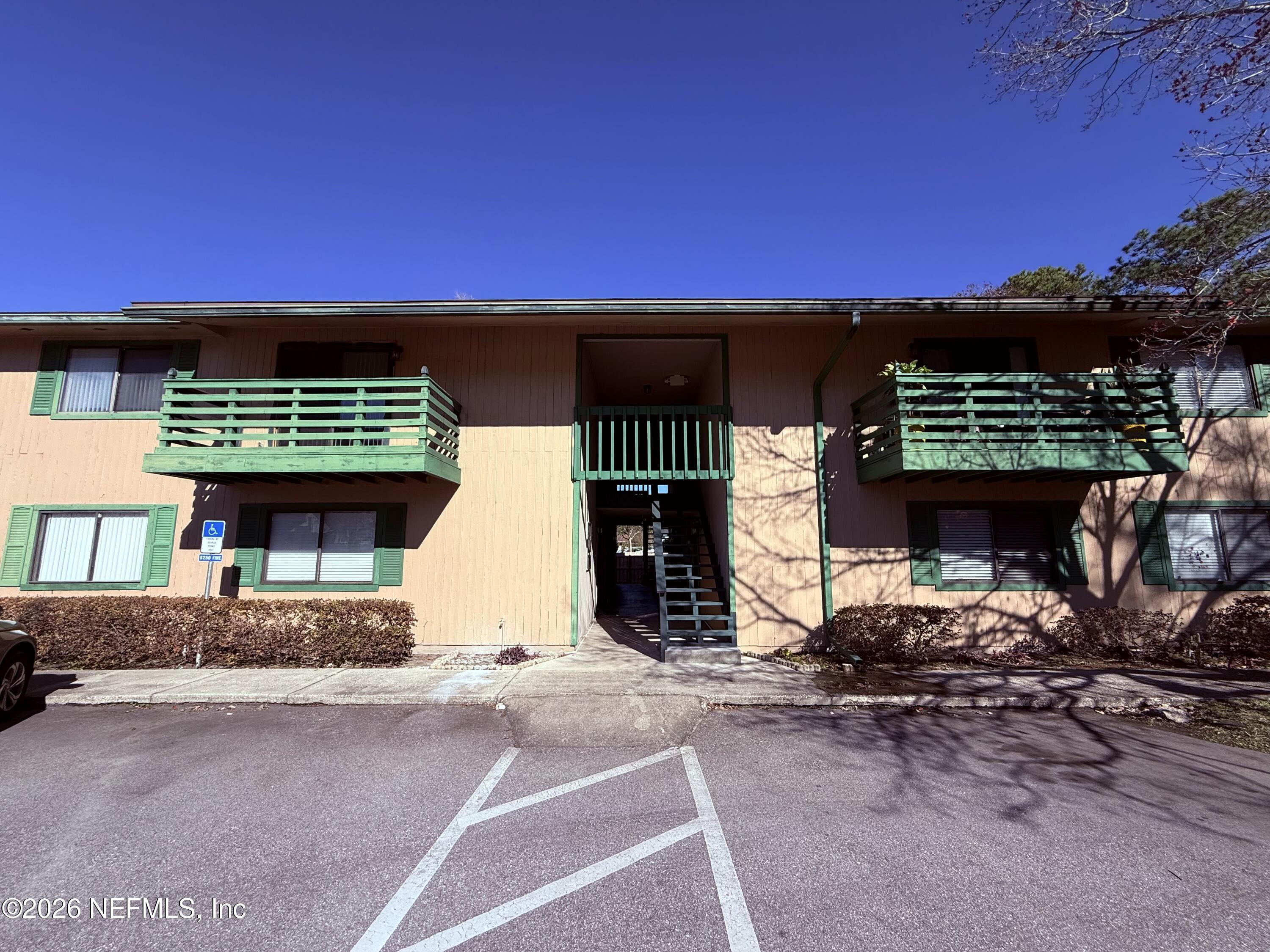 3765 Crown Point Road, Unit 13 Jacksonville, FL 32257 - Photo 2 of 37 a front view of a house with a yard