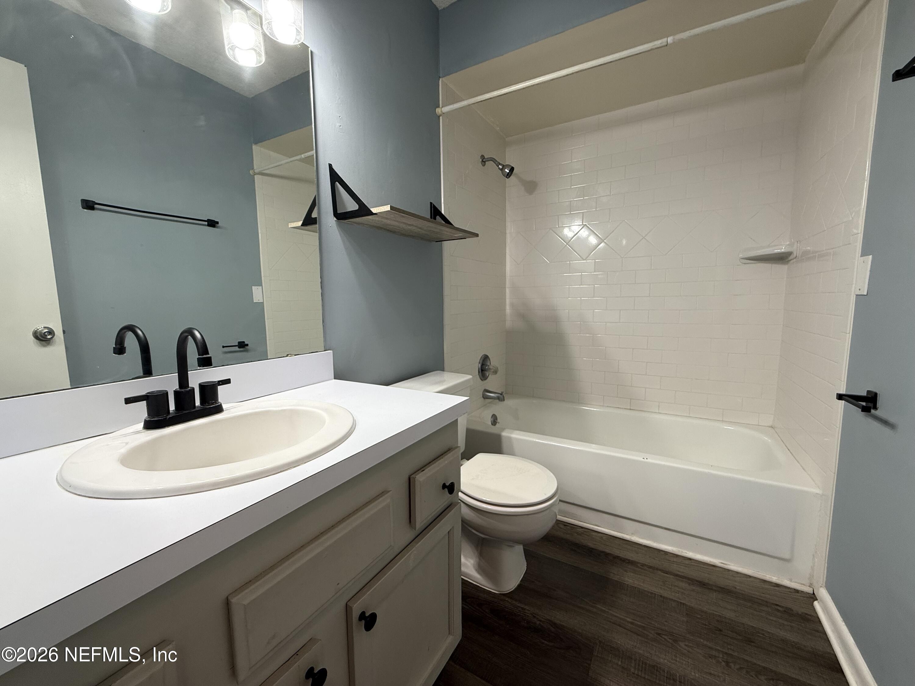 3765 Crown Point Road, Unit 13 Jacksonville, FL 32257 - Photo 25 of 37 a bathroom with a sink mirror toilet and bathtub