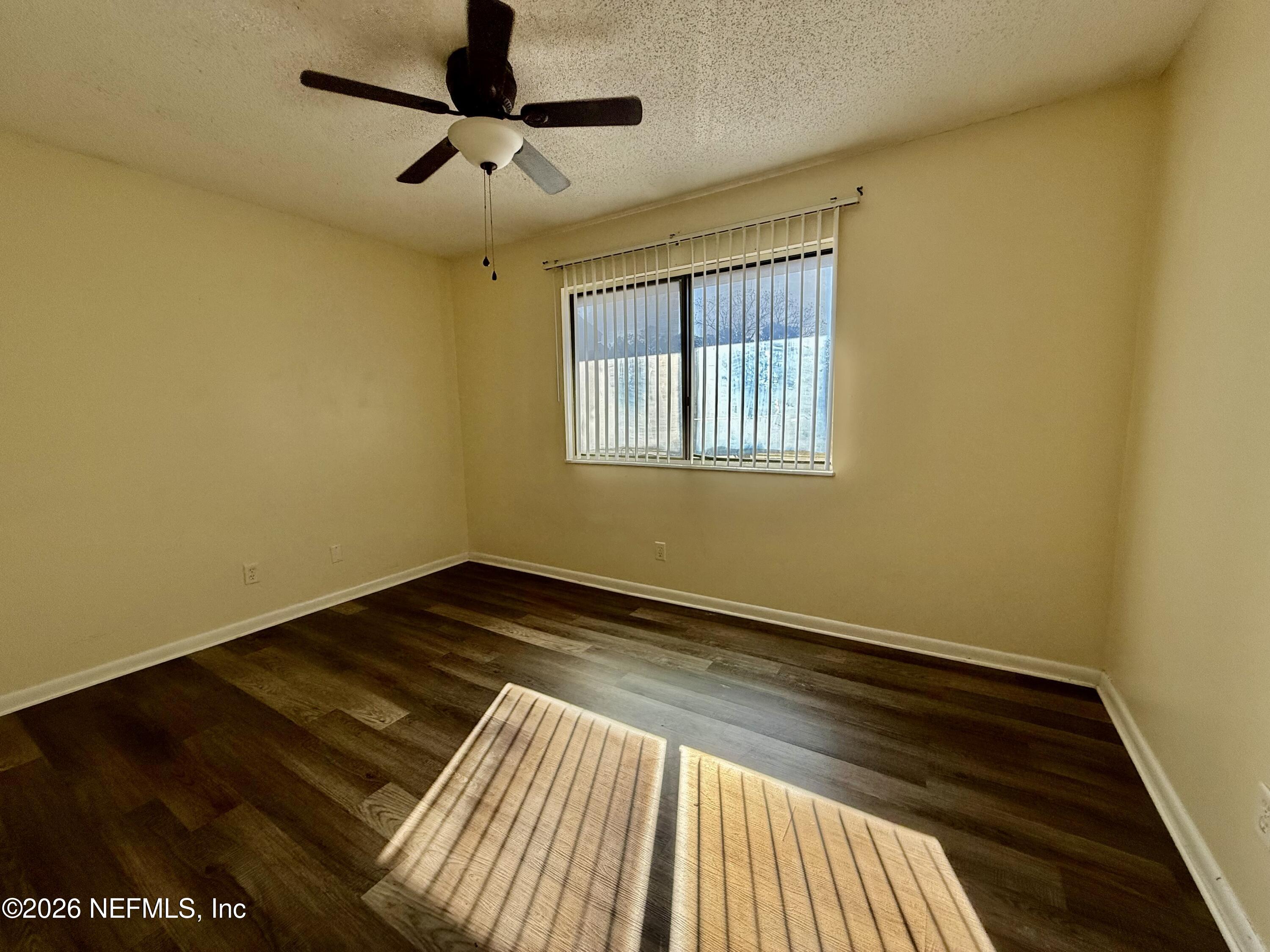 3765 Crown Point Road, Unit 13 Jacksonville, FL 32257 - Photo 26 of 37 a view of an empty room with wooden floor and a window