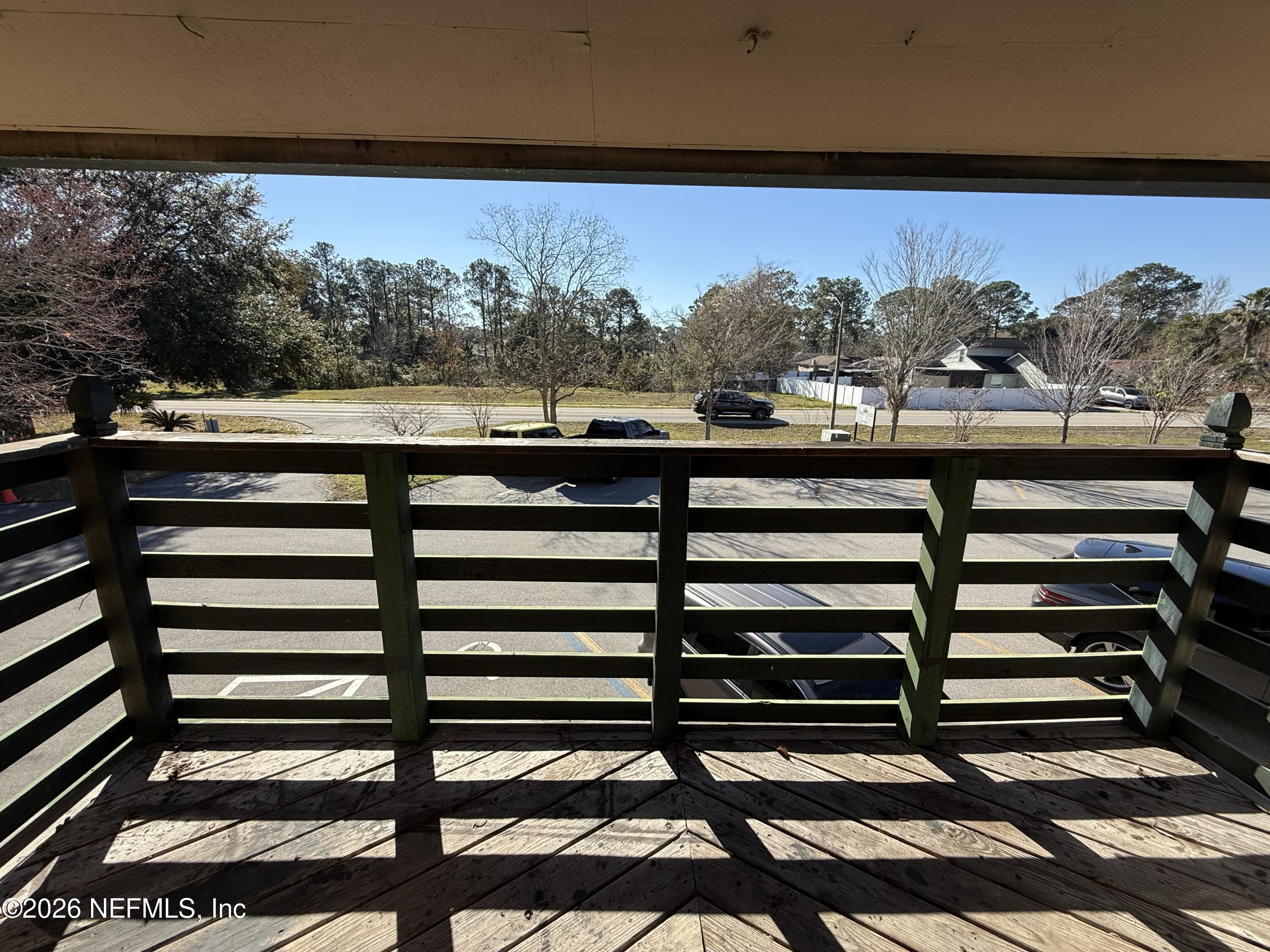 3765 Crown Point Road, Unit 13 Jacksonville, FL 32257 - Photo 35 of 37 a view of a balcony with wooden floor and outdoor space