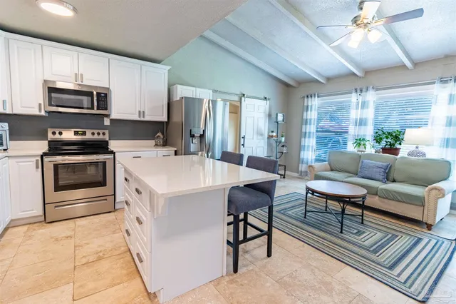 a kitchen with a stove a refrigerator and a sink