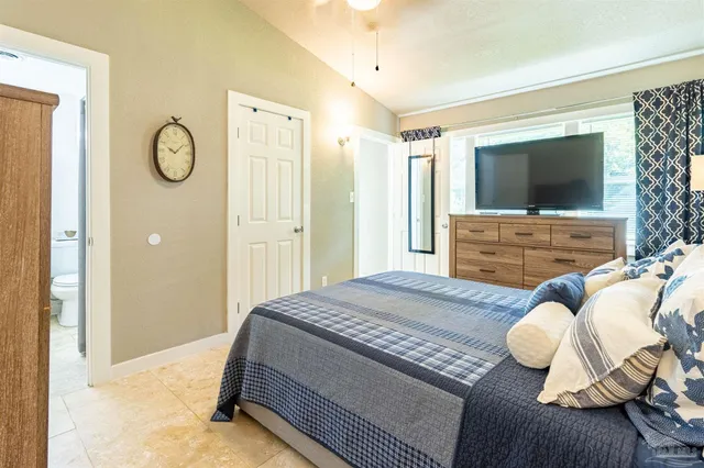 a bedroom with a bed and flat screen tv