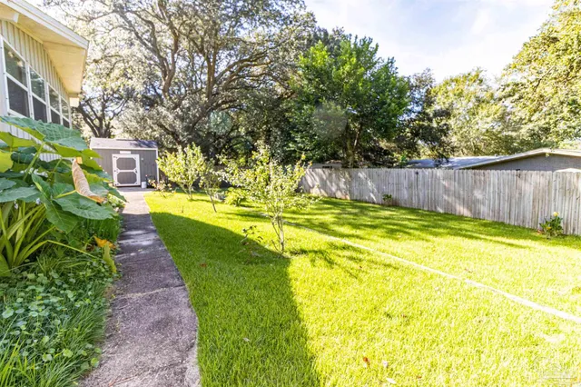 a swimming pool with outdoor seating and yard