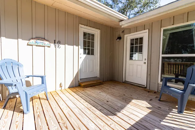 a view of a patio with wooden floor and furniture