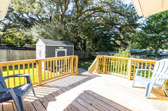 a view of balcony with wooden floor and fence