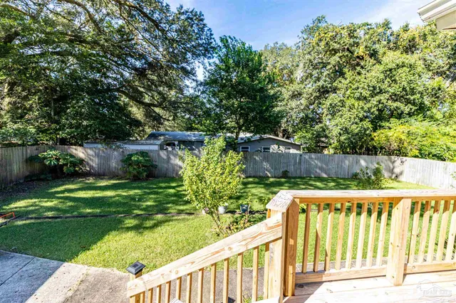 a view of a garden with wooden fence