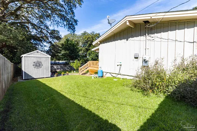 a view of a backyard with a garden and garage