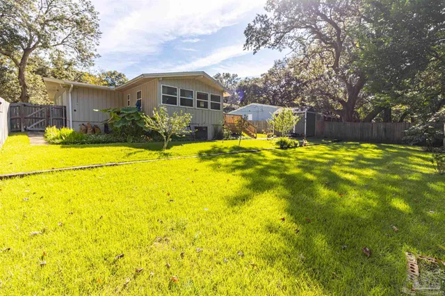 a view of a swimming pool with a patio and a yard