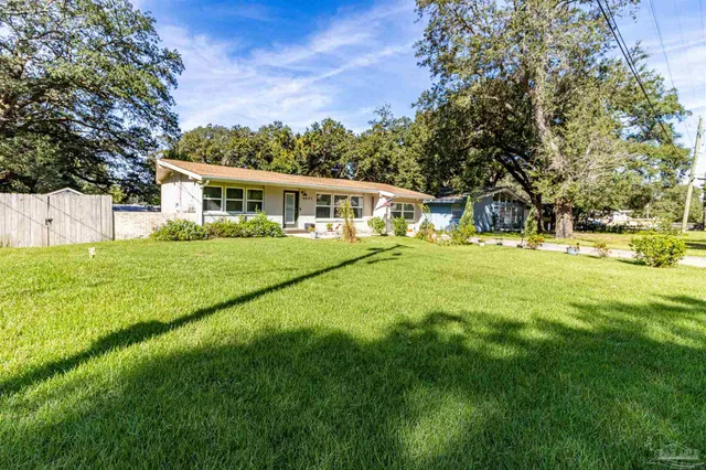 a front view of house with yard and green space