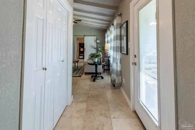 a view of a hallway with living room and furniture