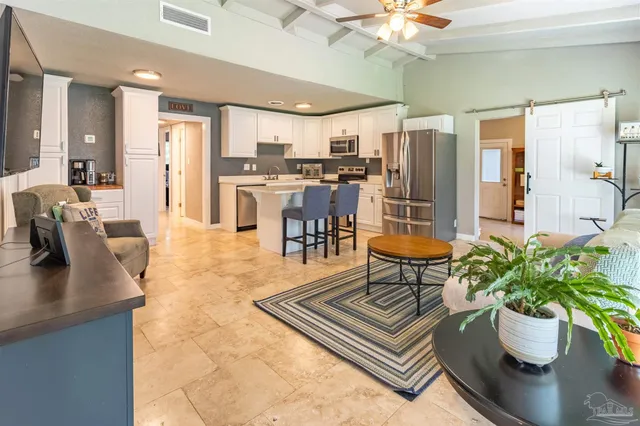 a living room with dining table furniture and a potted plant