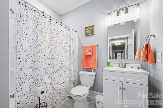 a bathroom with a sink toilet and mirror