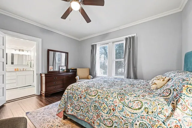 a bathroom with a toilet sink double vanity and mirror
