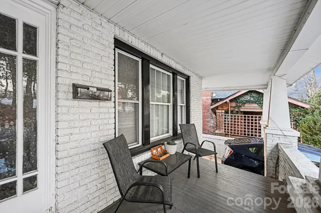 a balcony with chairs and wooden floor