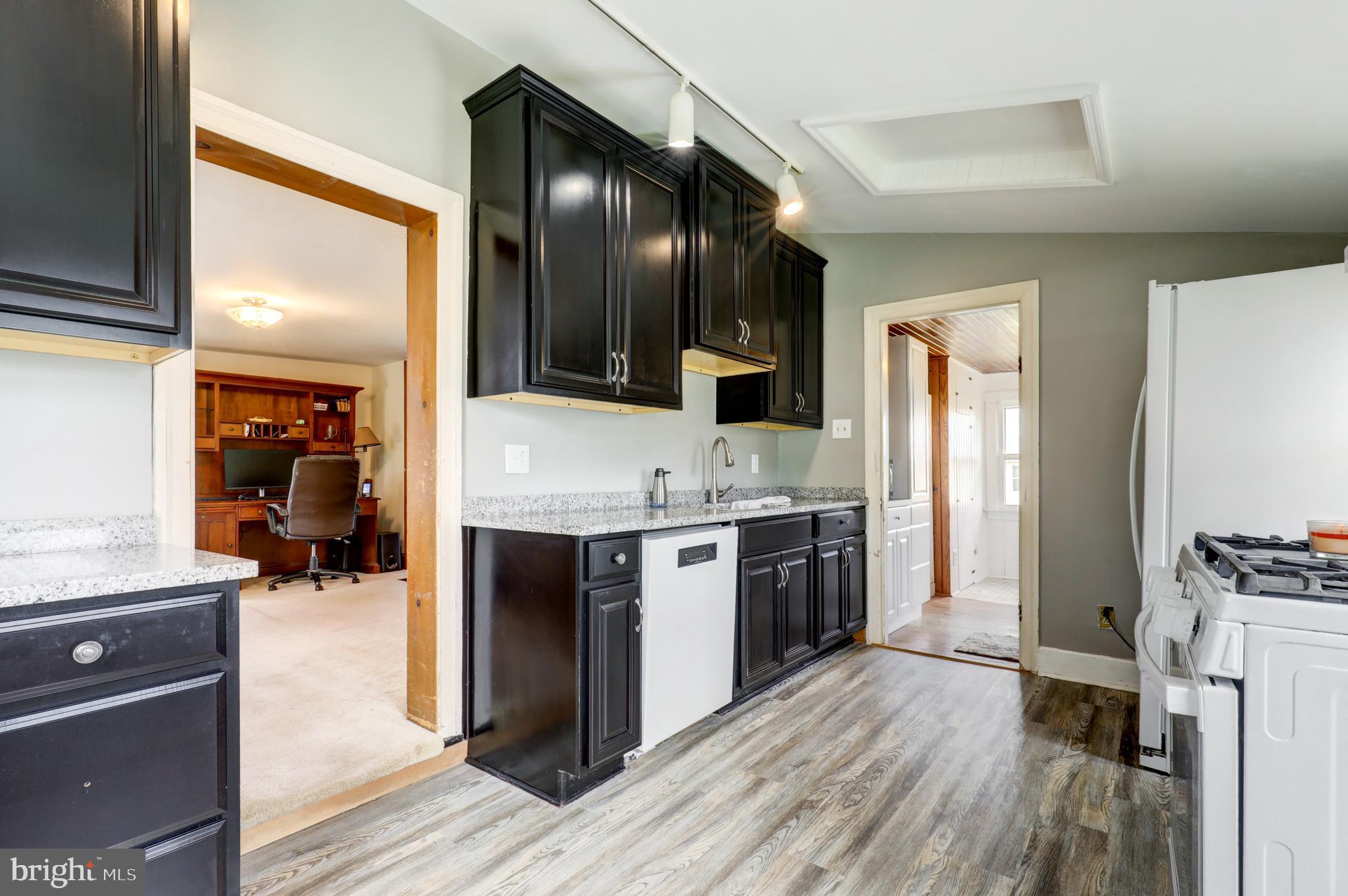 204 Roneys Corner Road Oxford, PA 19363 - Photo 11 of 33 a large kitchen with stainless steel appliances granite countertop a stove and a refrigerator