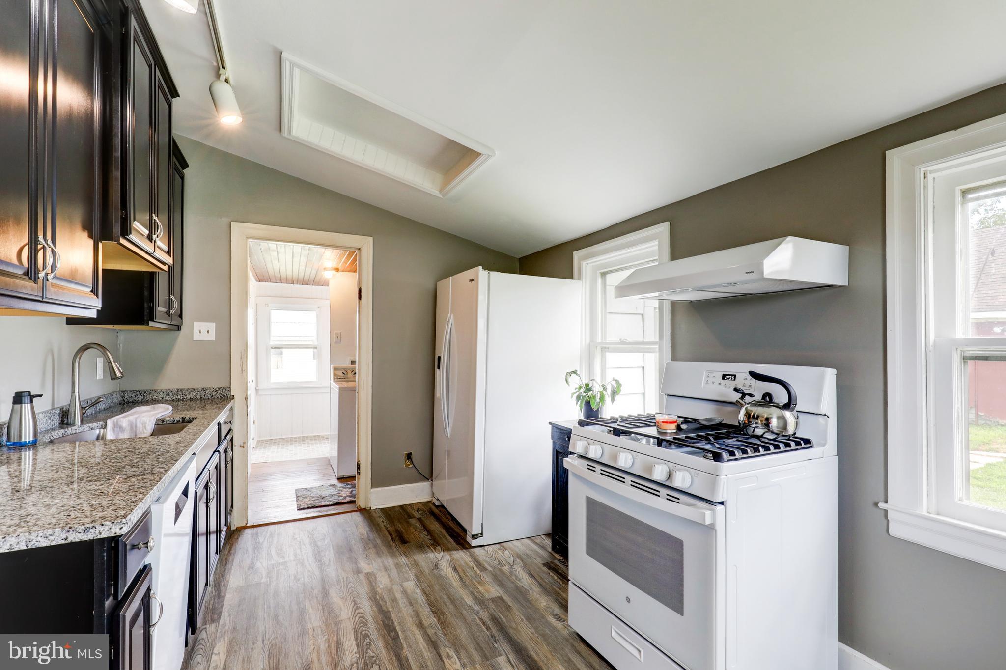 204 Roneys Corner Road Oxford, PA 19363 - Photo 12 of 33 a kitchen with granite countertop stainless steel appliances a sink stove top oven and cabinets