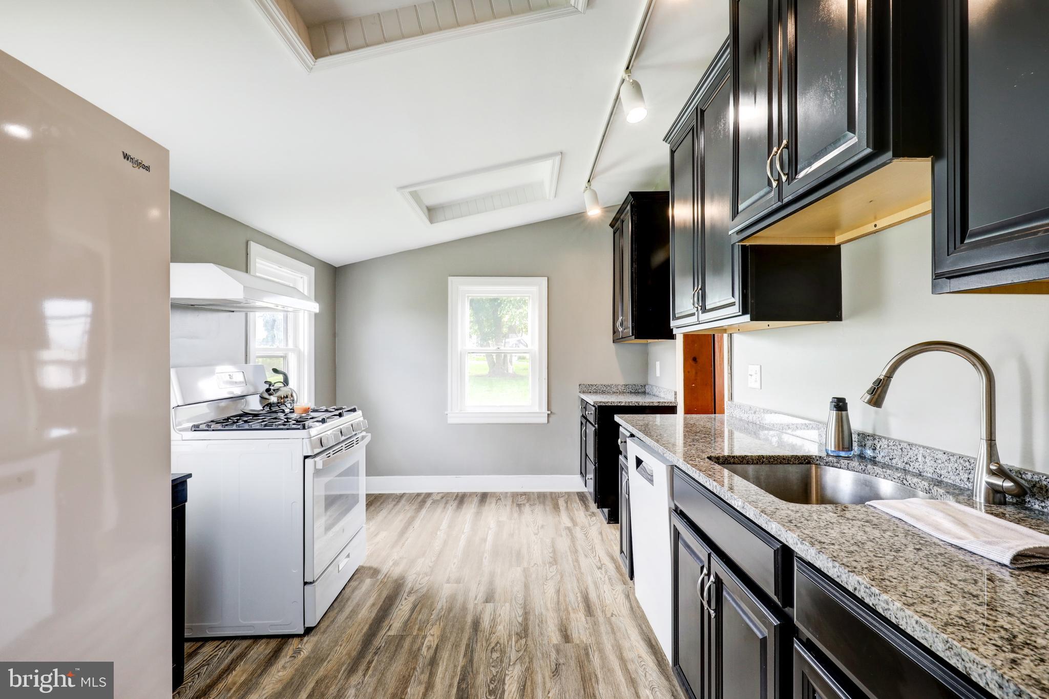 204 Roneys Corner Road Oxford, PA 19363 - Photo 10 of 33 a kitchen with stainless steel appliances granite countertop a sink stove and refrigerator