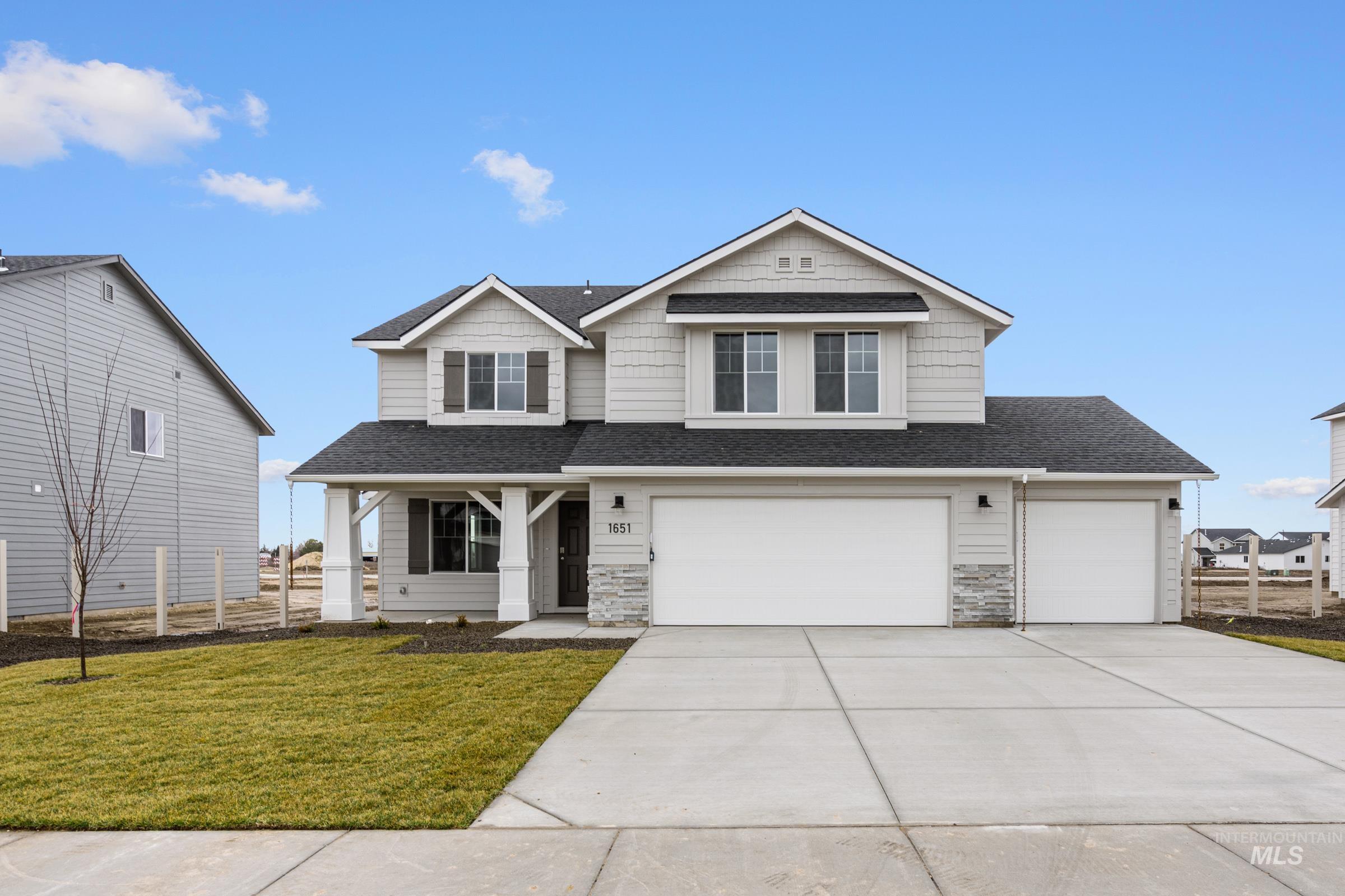1651 Dyer Street Middleton, ID 83644 - Photo 1 of 28 Craftsman inspired home featuring roof with shingles, concrete driveway, a garage, stone siding, and covered porch