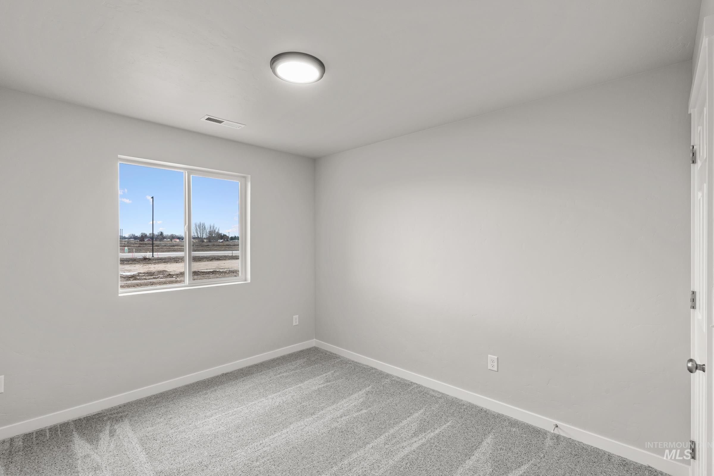 1651 Dyer Street Middleton, ID 83644 - Photo 12 of 28 Unfurnished room with light carpet and baseboards