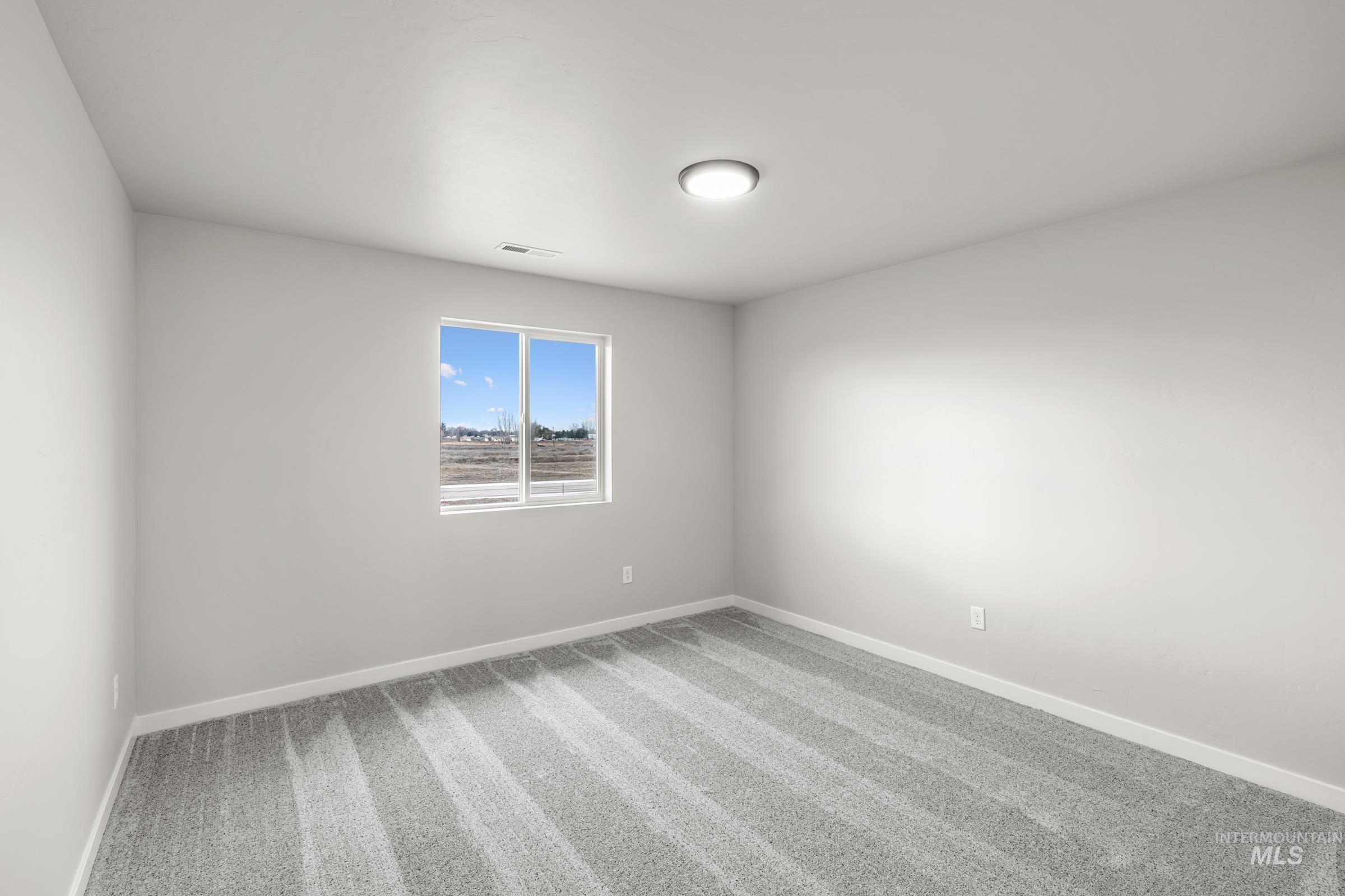1651 Dyer Street Middleton, ID 83644 - Photo 20 of 28 Unfurnished room with light colored carpet and baseboards