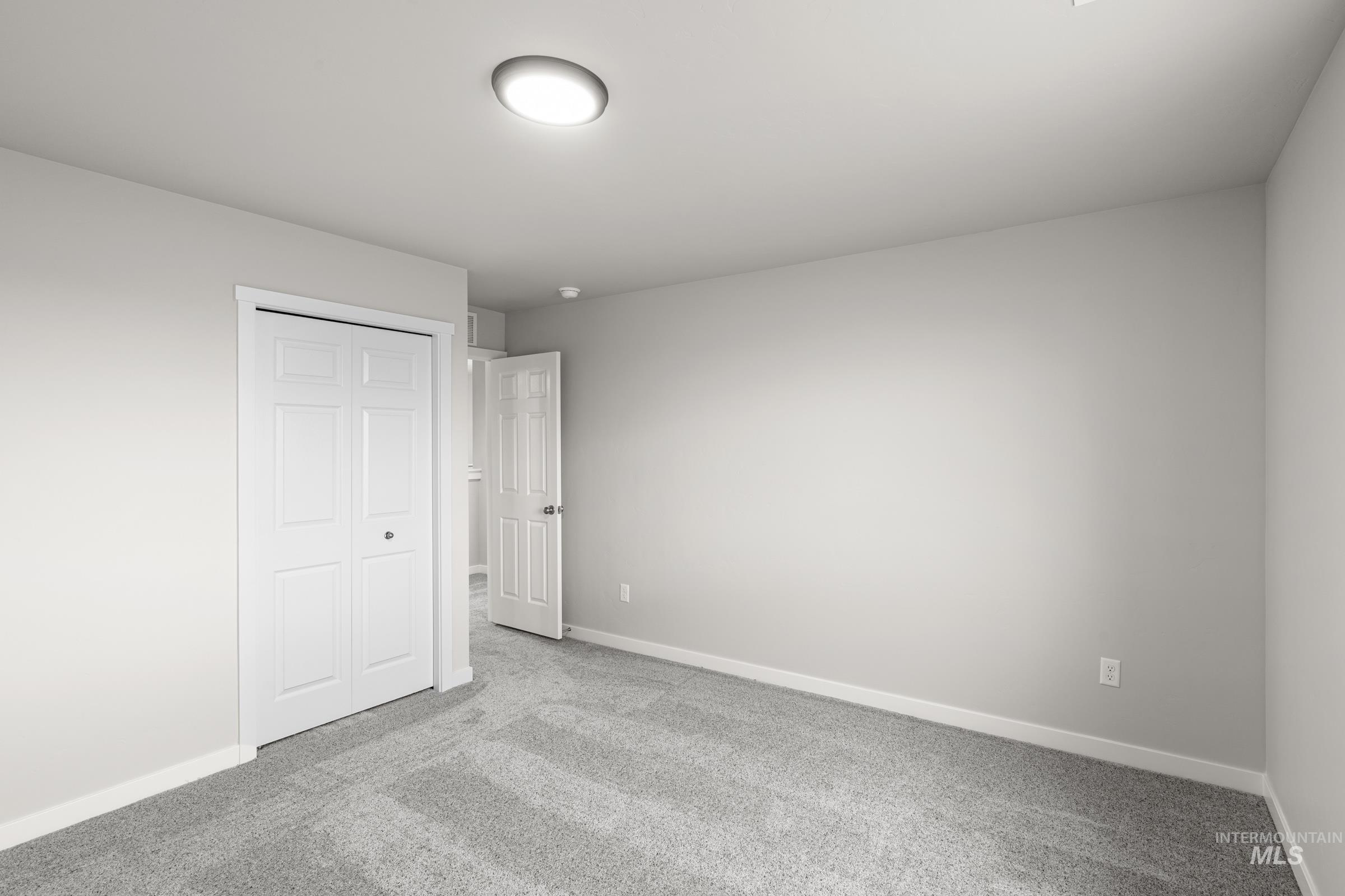 1651 Dyer Street Middleton, ID 83644 - Photo 21 of 28 Unfurnished bedroom with light carpet and a closet