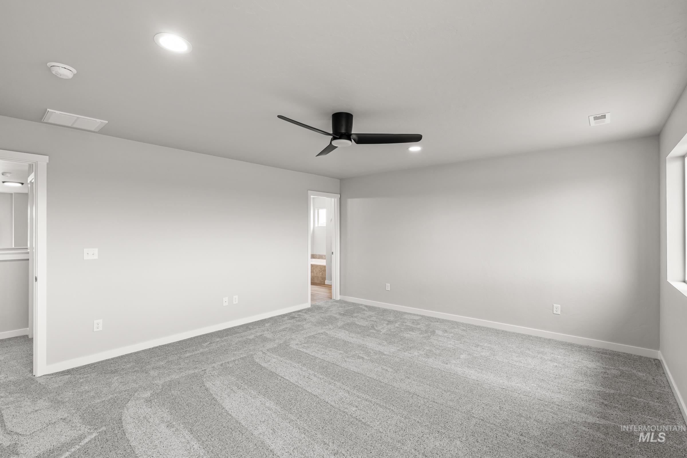 1651 Dyer Street Middleton, ID 83644 - Photo 23 of 28 Empty room with ceiling fan, light carpet, and recessed lighting