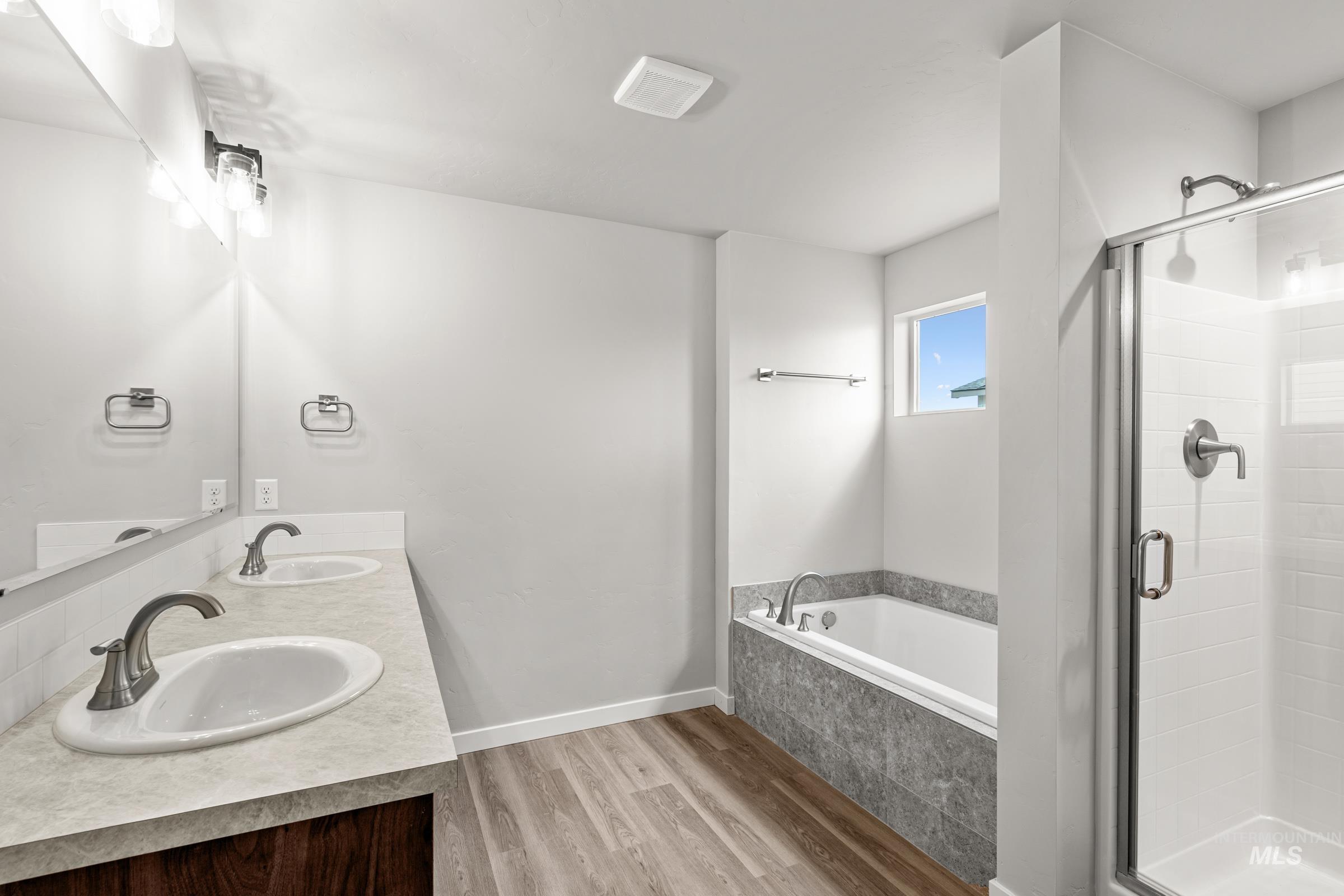 1651 Dyer Street Middleton, ID 83644 - Photo 25 of 28 Bathroom with light wood-style floors, a stall shower, a bath, and double vanity