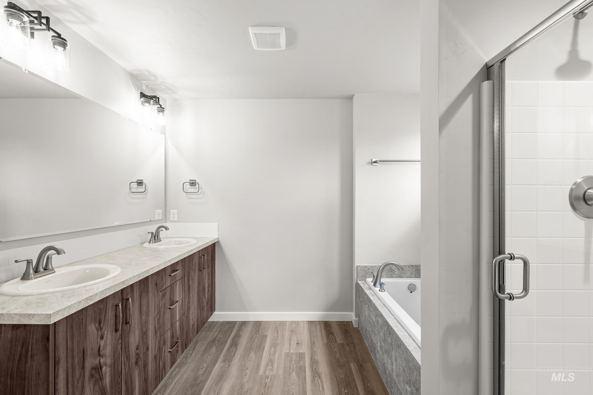 1651 Dyer Street Middleton, ID 83644 - Photo 26 of 28 Full bath with dark wood-style floors, double vanity, a stall shower, and a bath