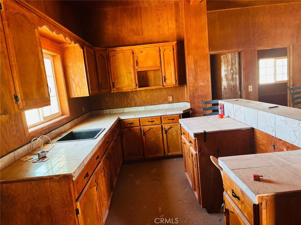 11690 Camp Rock Road Lucerne Valley, CA 92356 - Photo 11 of 33 a large kitchen with stainless steel appliances granite countertop a sink a stove and a refrigerator