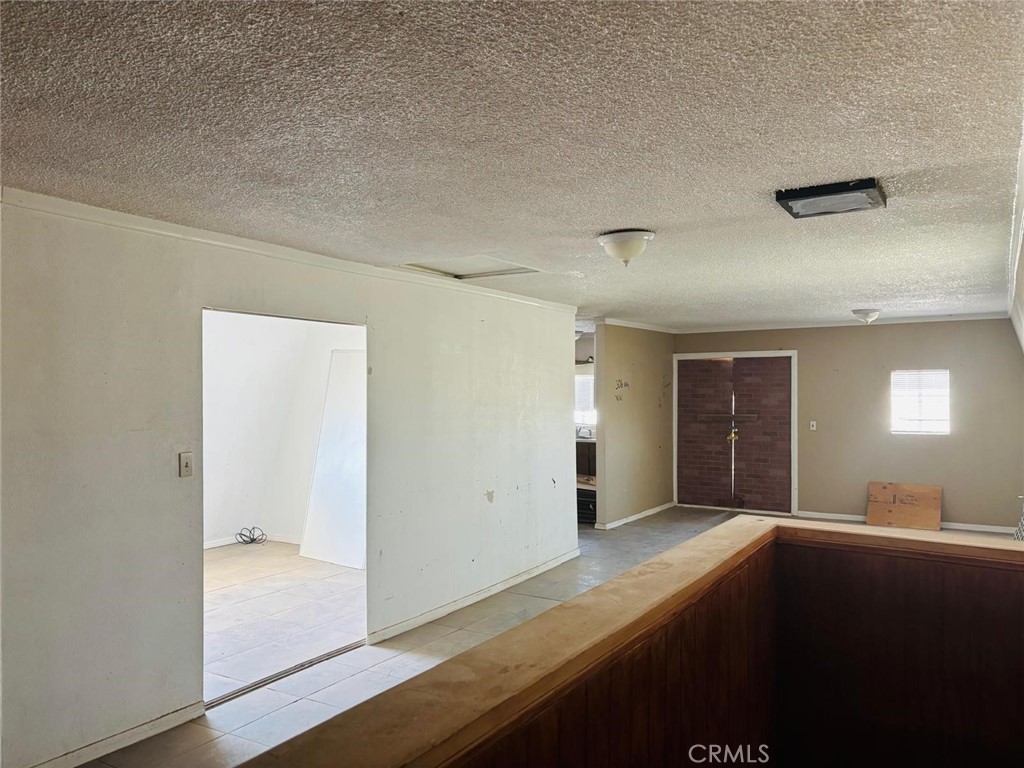 11690 Camp Rock Road Lucerne Valley, CA 92356 - Photo 15 of 33 an empty room with wooden floor and windows