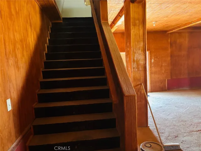 a view of a hallway with wooden shelves