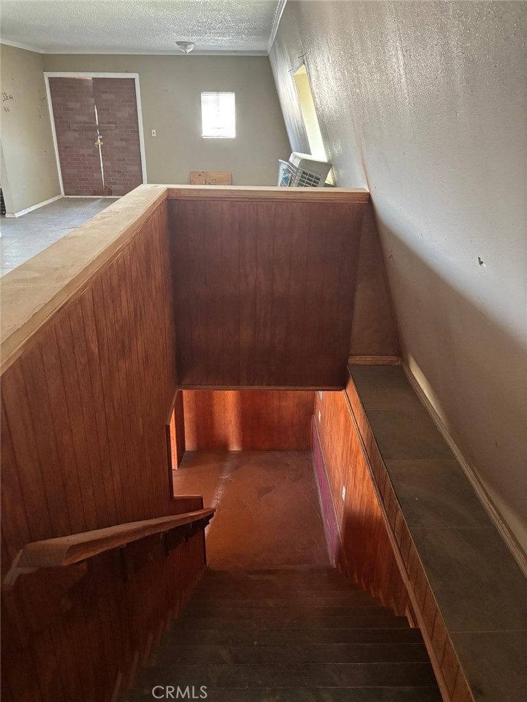 11690 Camp Rock Road Lucerne Valley, CA 92356 - Photo 19 of 33 a view of staircase with wooden floor and lamp