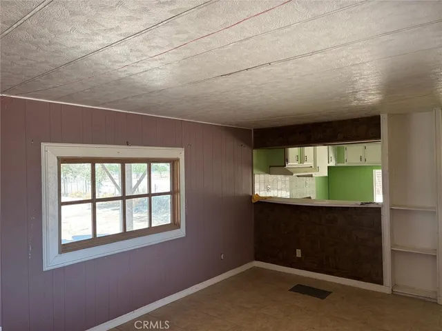 a view of hallway with stainless steel appliances wooden floor and staircase