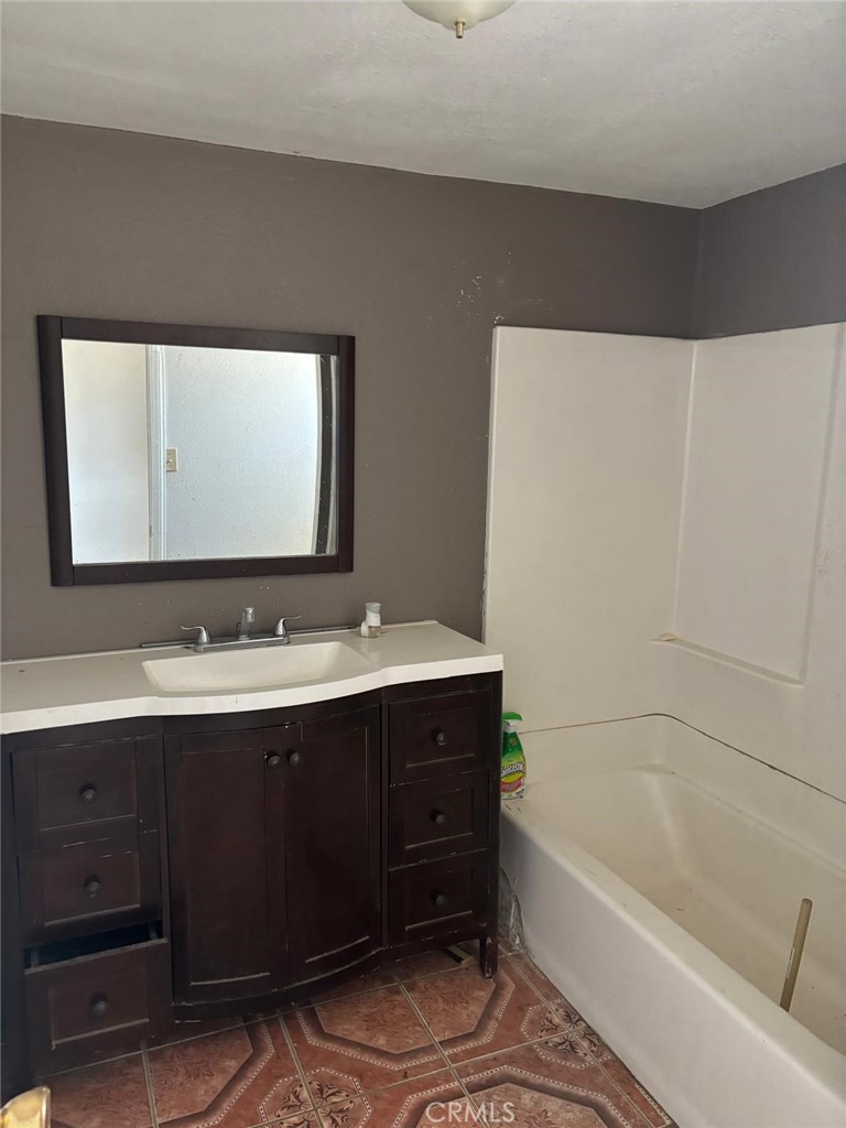 11690 Camp Rock Road Lucerne Valley, CA 92356 - Photo 30 of 33 a bathroom with a tub sink and mirror