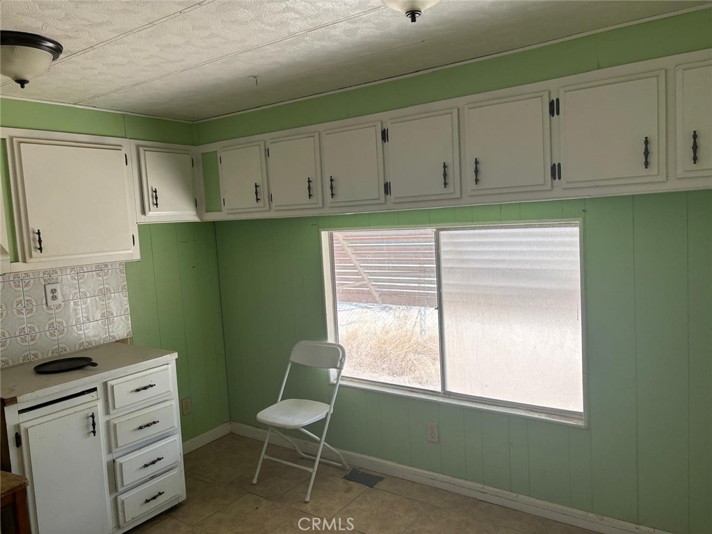 11690 Camp Rock Road Lucerne Valley, CA 92356 - Photo 32 of 33 a room with cabinets and a window
