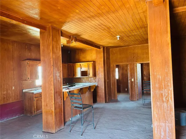 a view of a hallway with wooden shelves