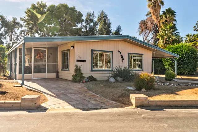 a front view of a house with a yard and glass windows