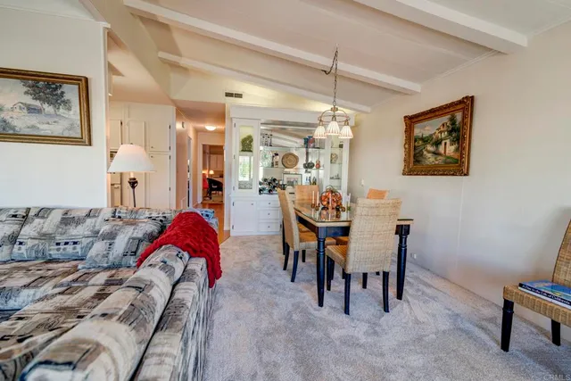 a view of a dining room with furniture and chandelier