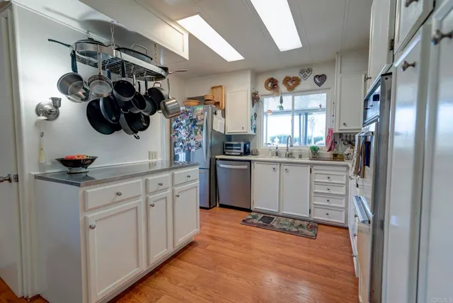 a kitchen with a refrigerator and cabinets