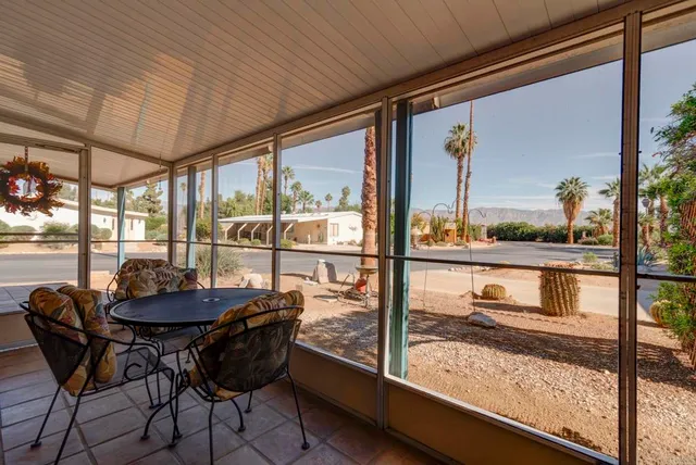 a view of a room with furniture and wooden floor