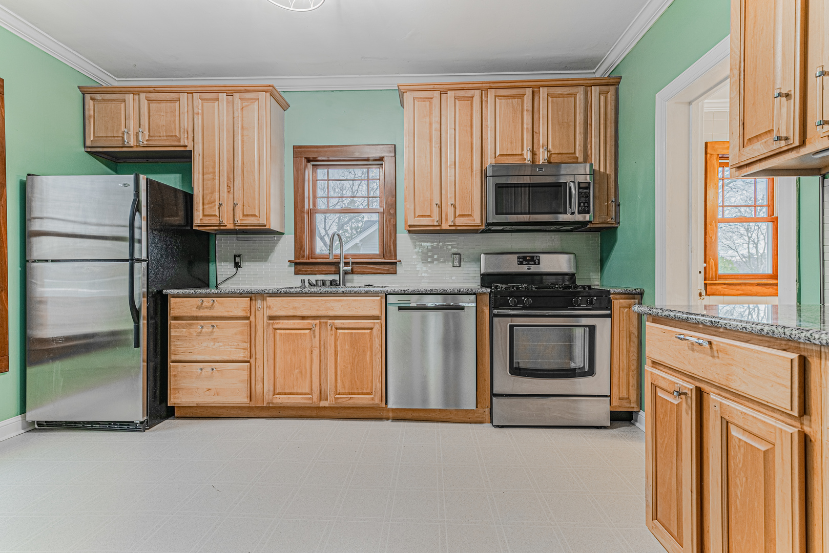 1507 Riverside Drive McHenry, IL 60050 - Photo 11 of 27 a kitchen with stainless steel appliances granite countertop a stove a sink and a refrigerator