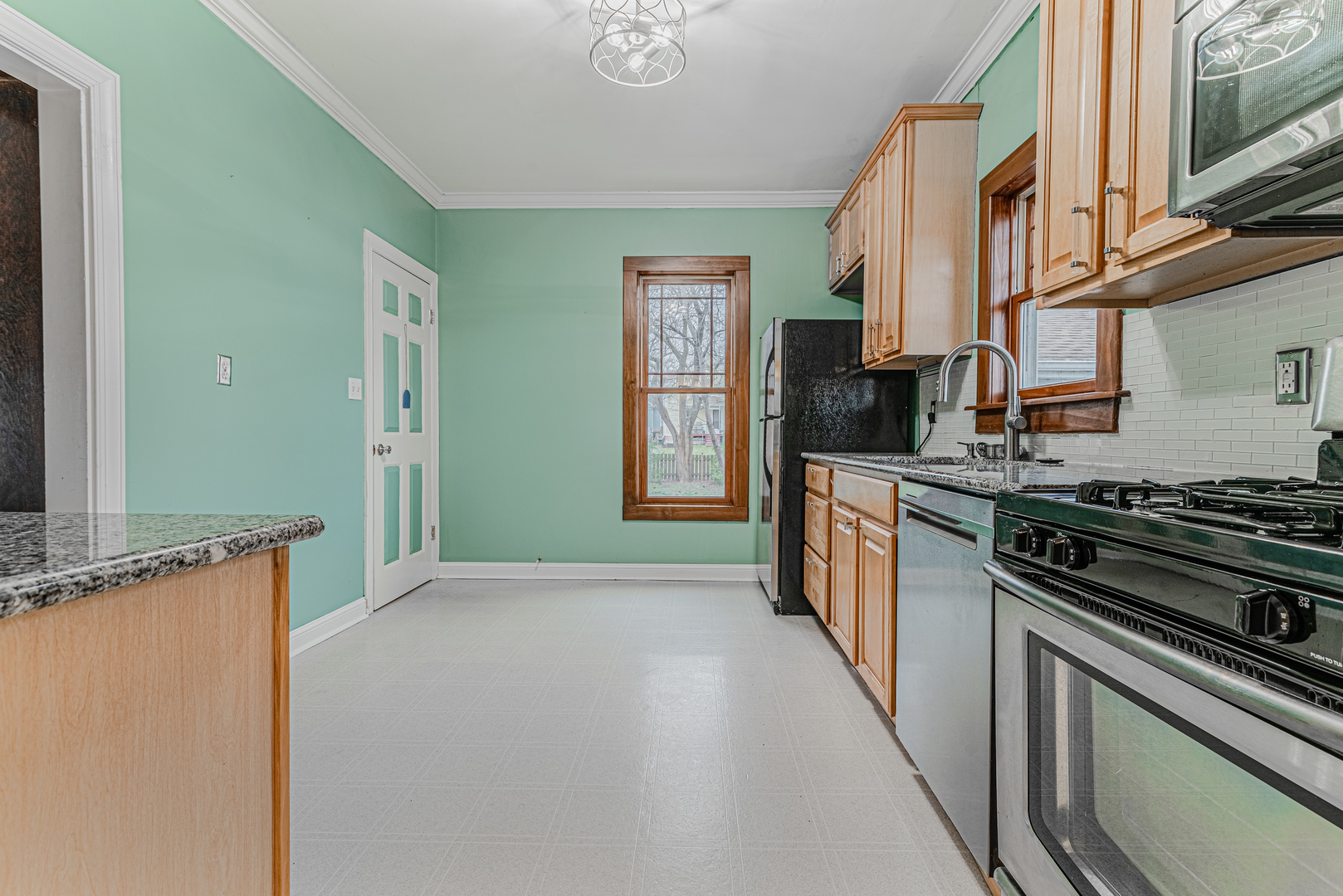 1507 Riverside Drive McHenry, IL 60050 - Photo 13 of 27 a kitchen with stainless steel appliances granite countertop a stove and a refrigerator