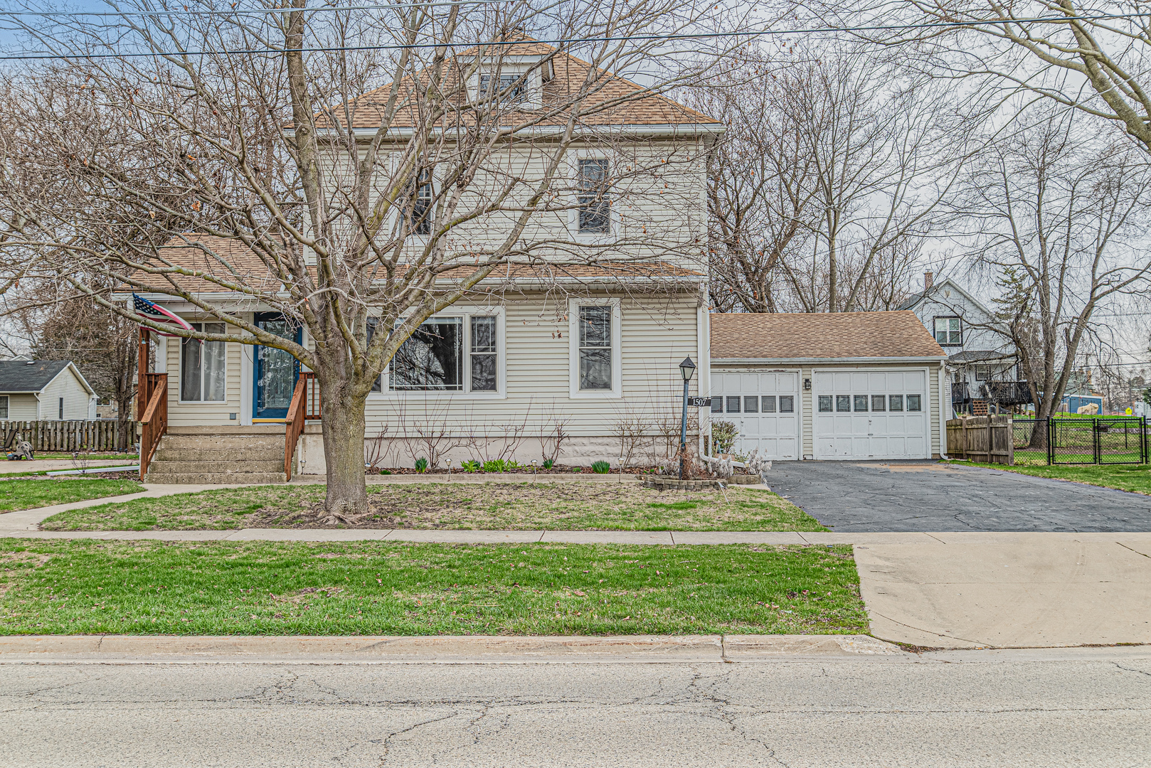 1507 Riverside Drive McHenry, IL 60050 - Photo 7 of 27 a front view of a house with a garden and trees