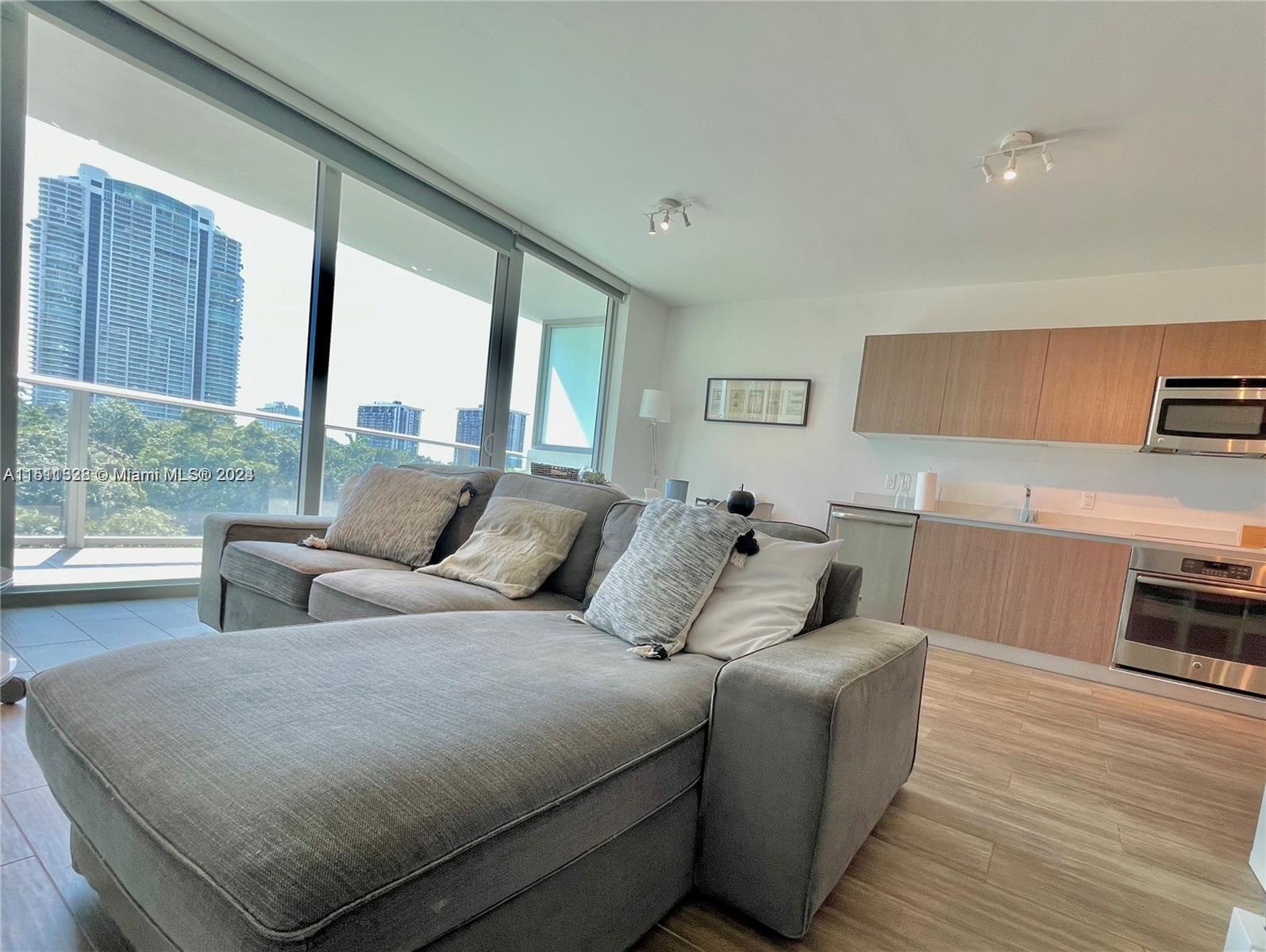 1600 Southwest 1st Avenue, Unit 511 Miami, FL 33129 - Photo 2 of 10 a living room with furniture and a large window