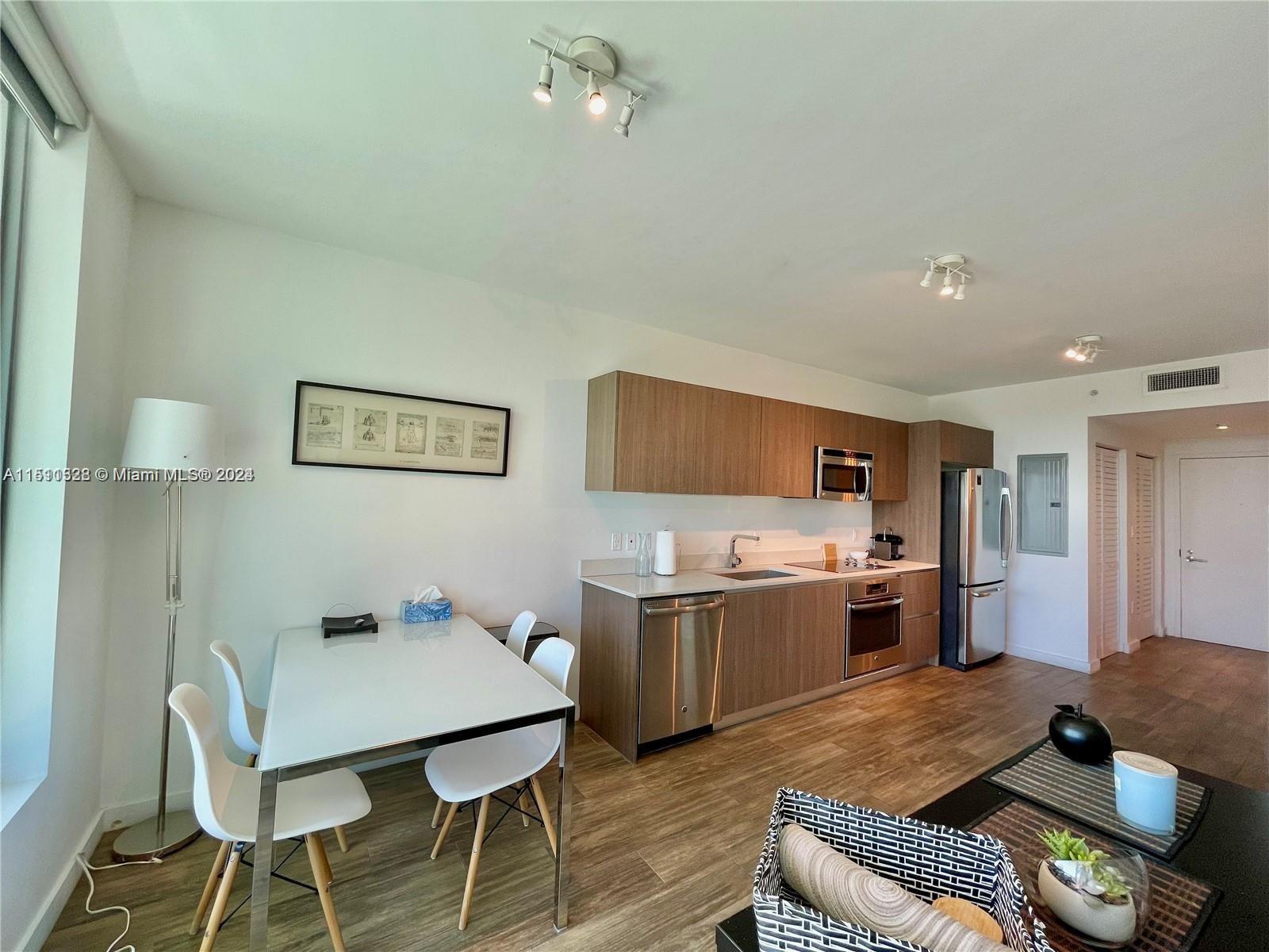 1600 Southwest 1st Avenue, Unit 511 Miami, FL 33129 - Photo 3 of 10 a living room with furniture and kitchen view