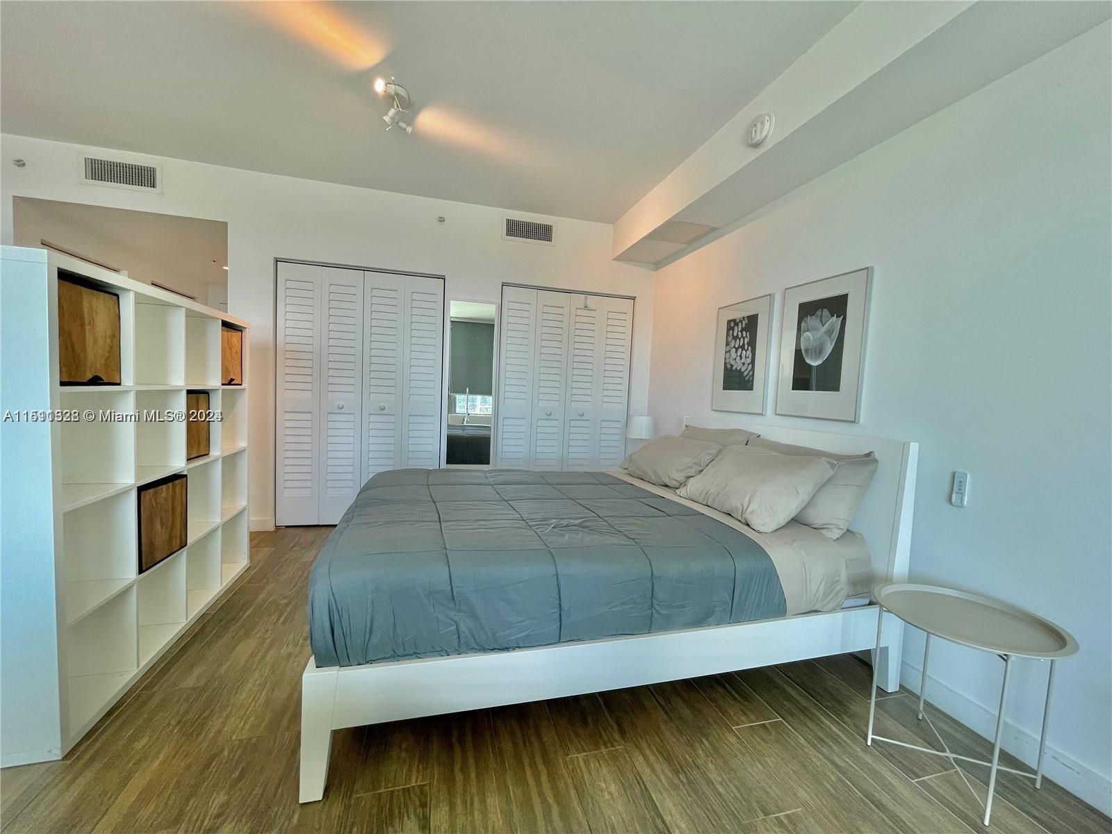 1600 Southwest 1st Avenue, Unit 511 Miami, FL 33129 - Photo 5 of 10 a bedroom with a bed and cabinet