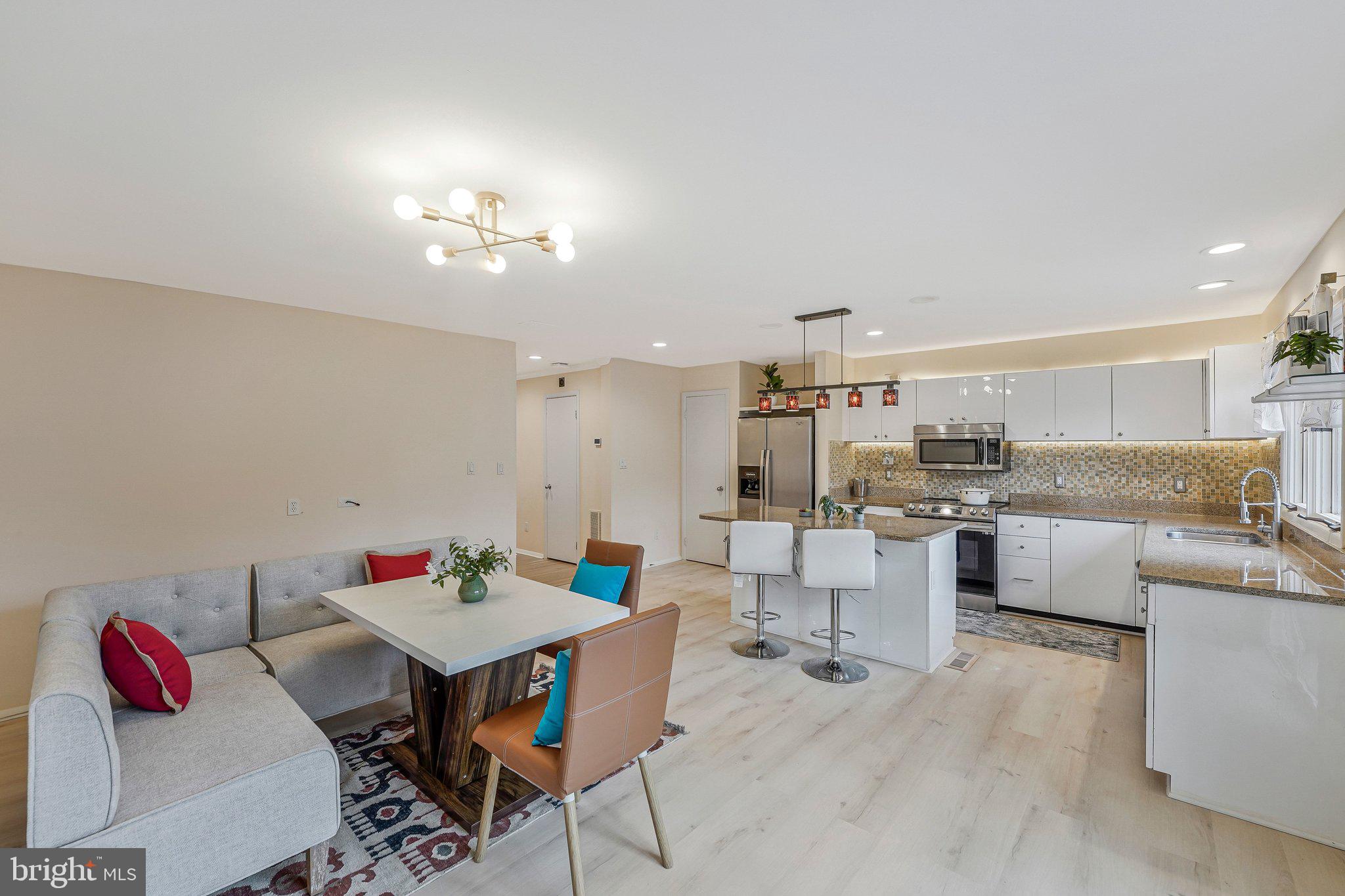 11123 Lakespray Way Reston, VA 20191 - Photo 11 of 47 a living room with lots of furniture and kitchen view